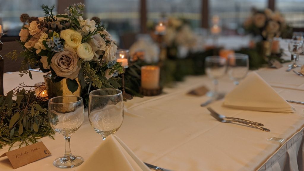 floral centerpiece with with greenery along the table
