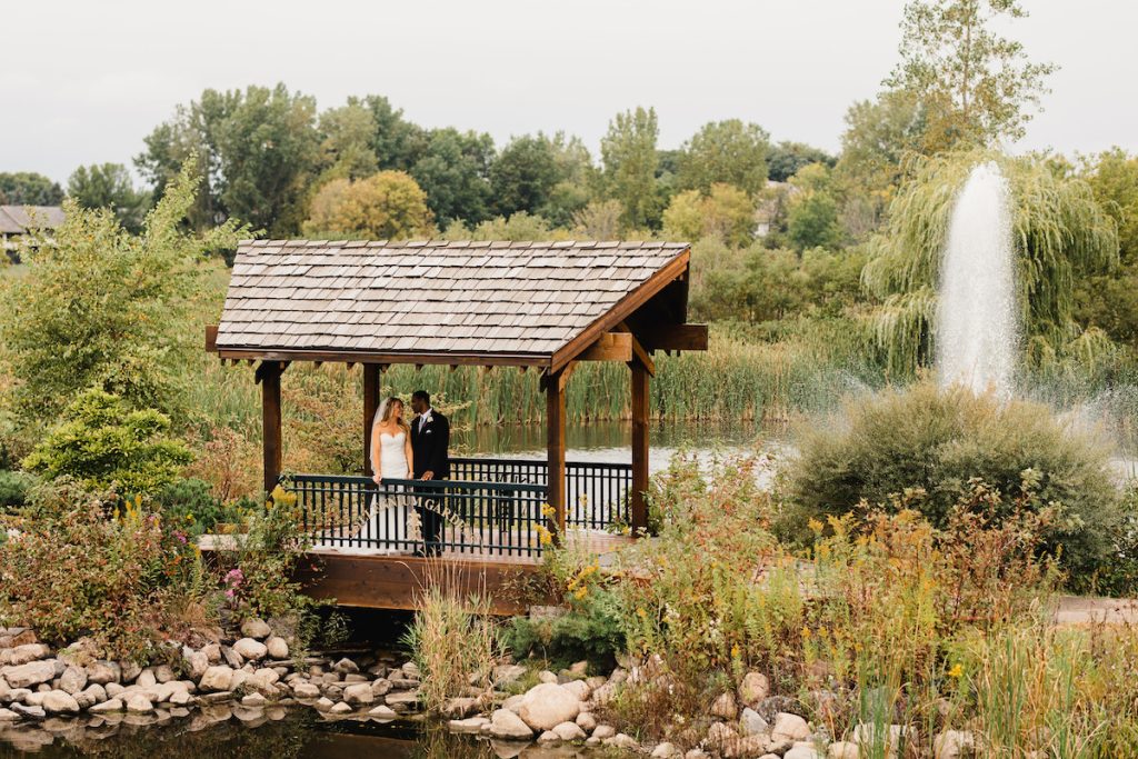 couple on covered bridge with fountain