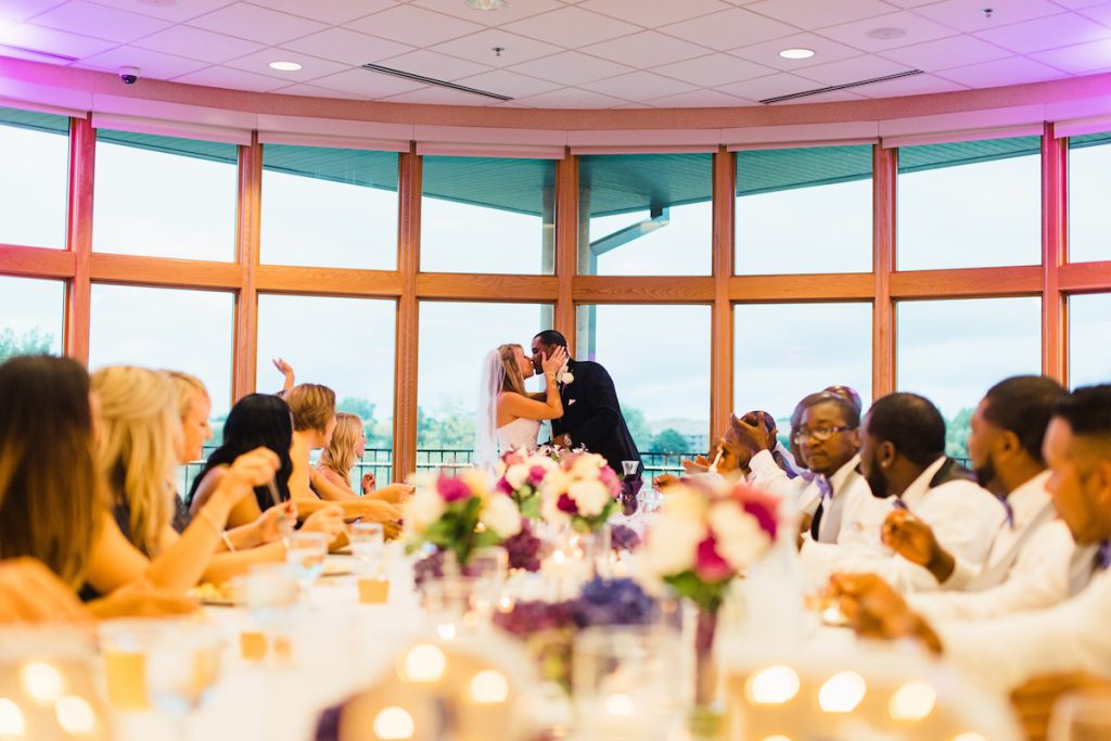 couple kissing at wedding reception