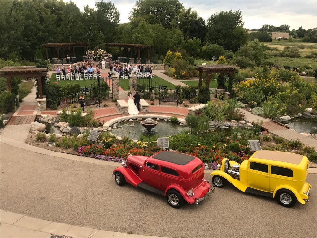 Outdoor wedding red and yellow cars theme